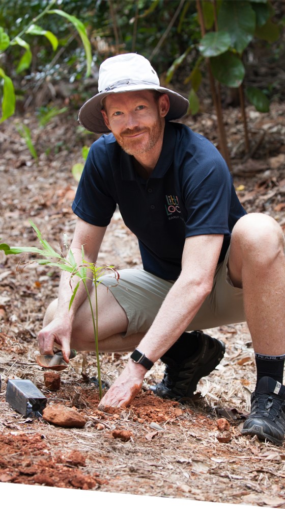 Little Locals Early Learning Centre Manager Tim plants a tree in the Daintree Rainforest, upholding the centre’s ethos of practising sustainability in childcare.